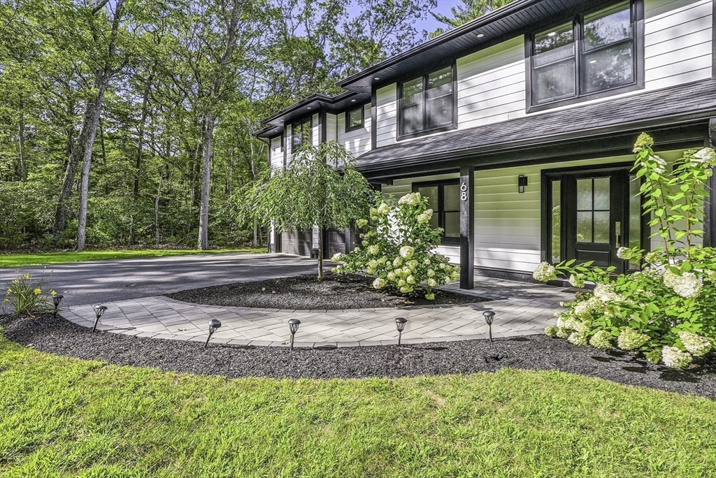 68 Pearl Street Upton, MA 01568 - Photo 4 of 37 a front view of a house with a yard and a garage