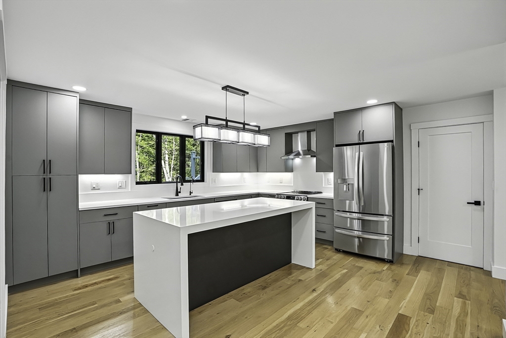 68 Pearl Street Upton, MA 01568 - Photo 5 of 37 a kitchen with stainless steel appliances granite countertop a sink stove and refrigerator