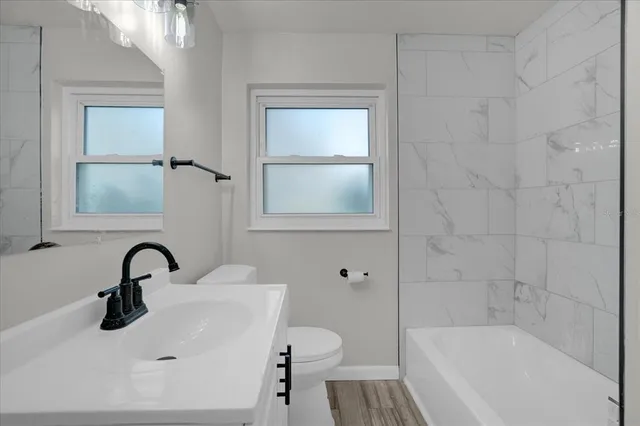a bathroom with a bathtub and shower