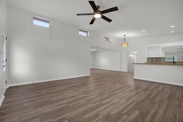 a view of a kitchen with a dishwasher and wooden floor