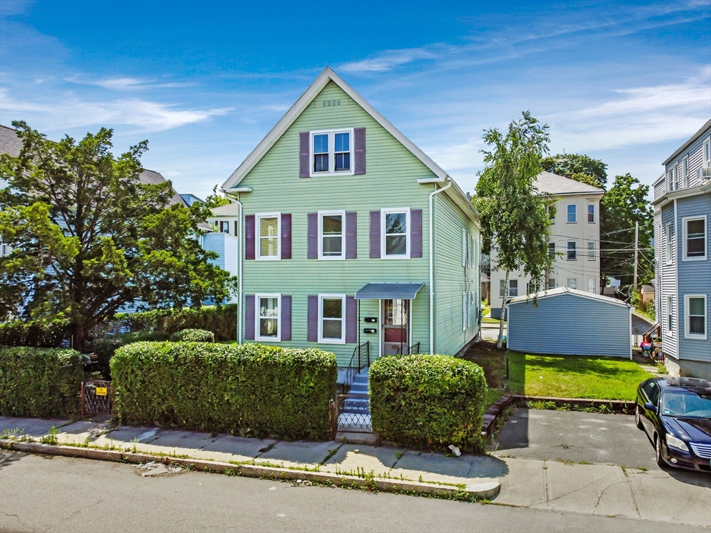 a front view of a house with garden