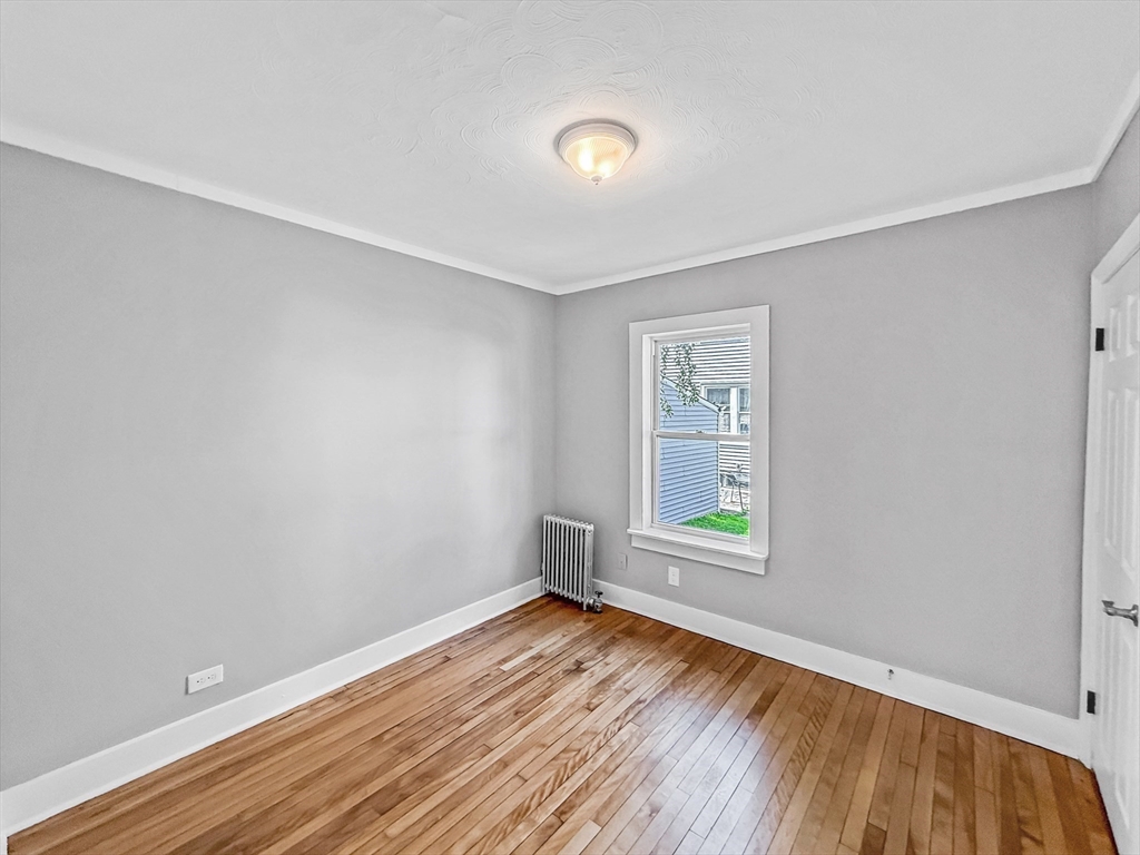 70 Cutler Street Worcester, MA 01604 - Photo 15 of 42 an empty room with wooden floor and windows