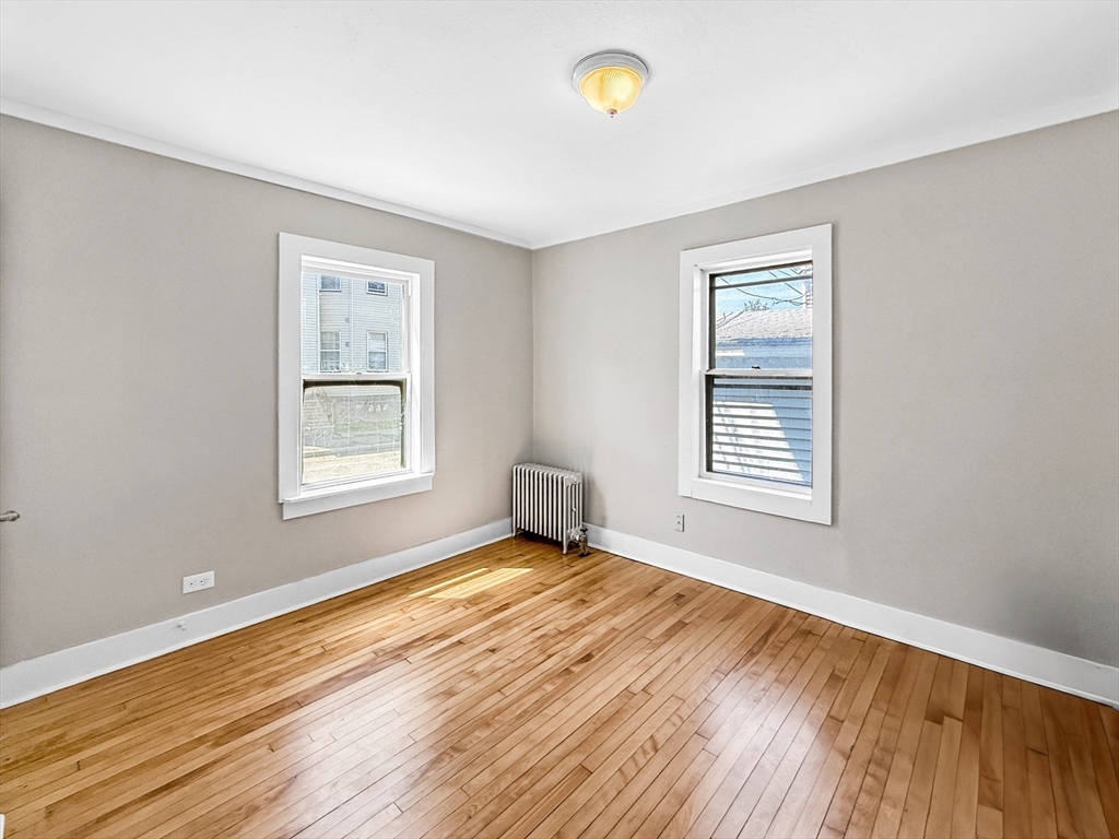 70 Cutler Street Worcester, MA 01604 - Photo 18 of 42 a view of an empty room with wooden floor and a window