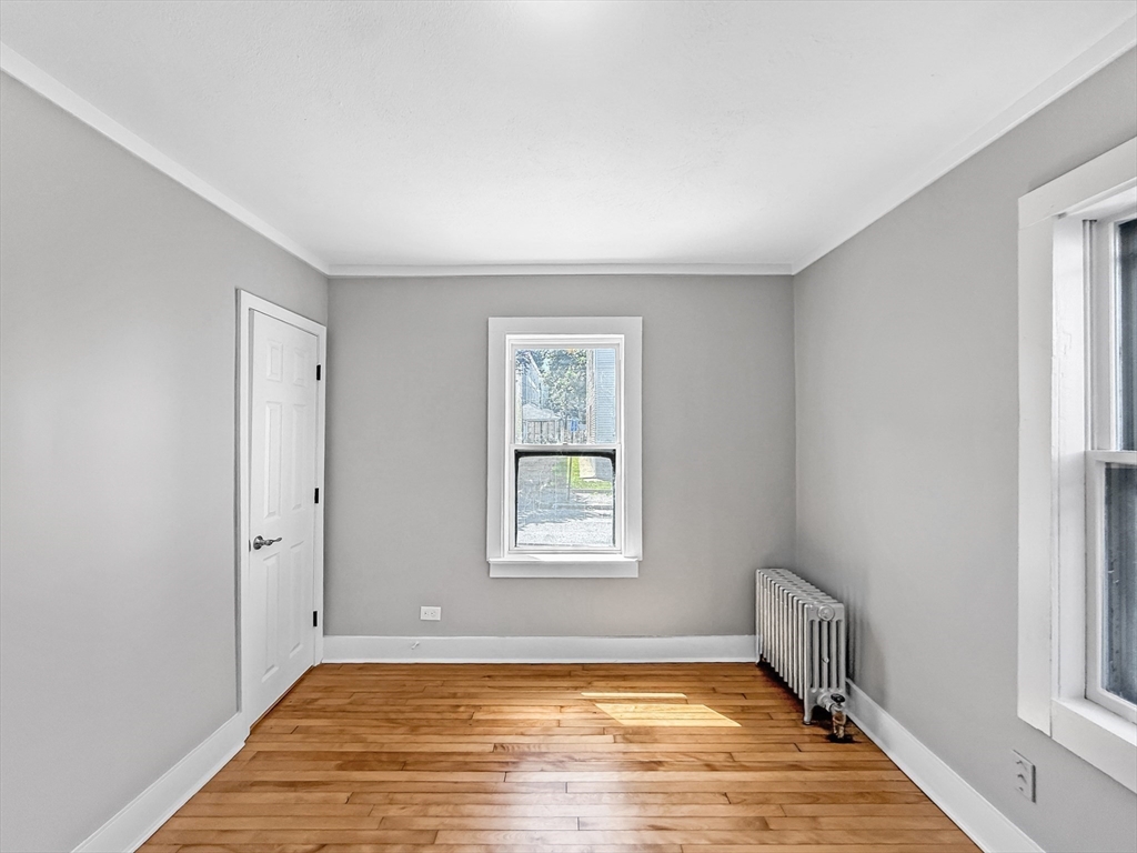 70 Cutler Street Worcester, MA 01604 - Photo 19 of 42 a view of an empty room with window and wooden floor