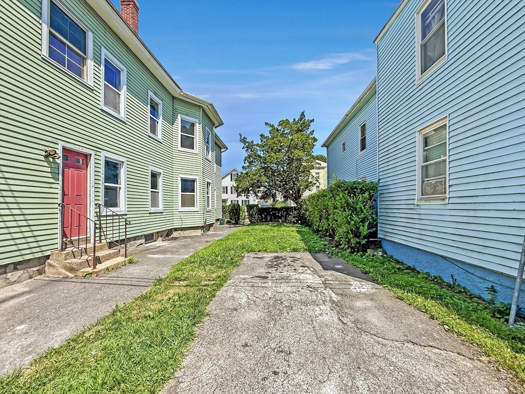 70 Cutler Street Worcester, MA 01604 - Photo 2 of 42 a front view of a house with a yard and potted plants