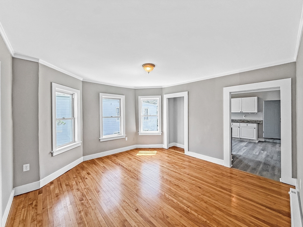 70 Cutler Street Worcester, MA 01604 - Photo 21 of 42 a view of an empty room with wooden floor and a window