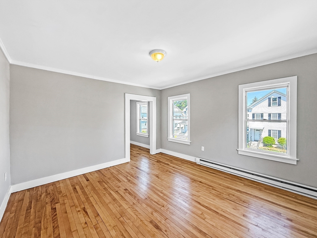 70 Cutler Street Worcester, MA 01604 - Photo 24 of 42 a view of an empty room with window and wooden floor