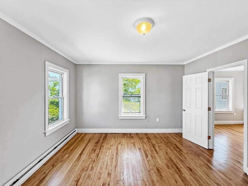 70 Cutler Street Worcester, MA 01604 - Photo 26 of 42 an empty room with wooden floor and windows