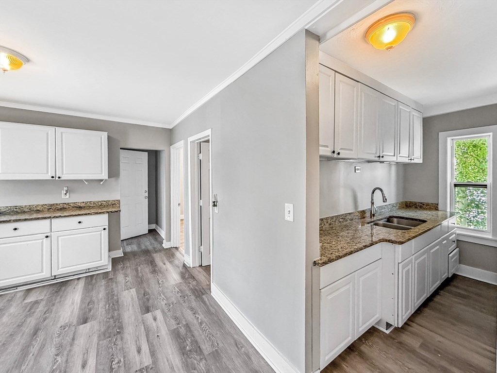 70 Cutler Street Worcester, MA 01604 - Photo 29 of 42 a kitchen with granite countertop a sink stove and cabinets