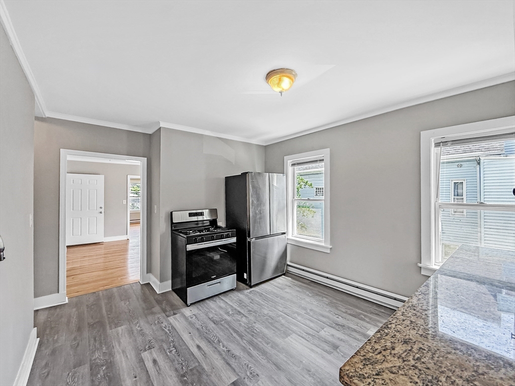 70 Cutler Street Worcester, MA 01604 - Photo 32 of 42 a view of a kitchen with a stove cabinets and wooden floor