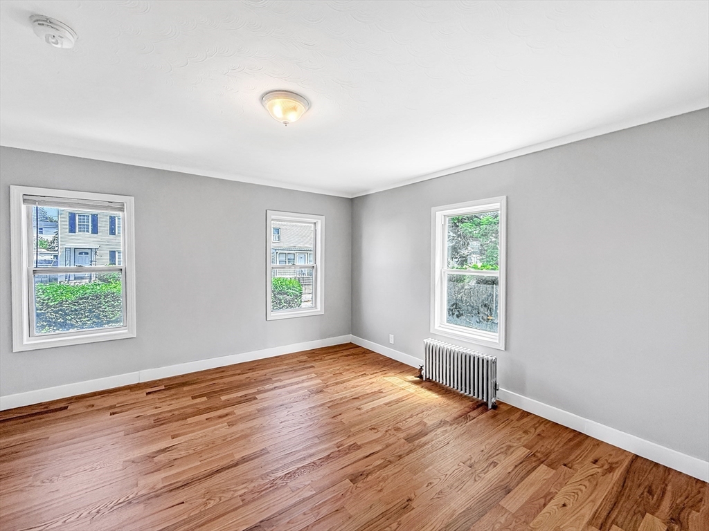 70 Cutler Street Worcester, MA 01604 - Photo 7 of 42 an empty room with wooden floor and windows