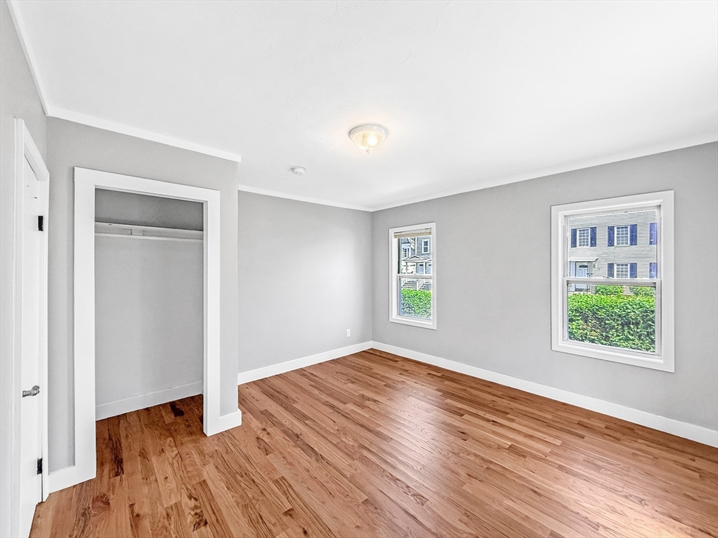 70 Cutler Street Worcester, MA 01604 - Photo 9 of 42 a view of an empty room with wooden floor and a window