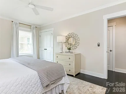 a bedroom with a bed and a dresser in it