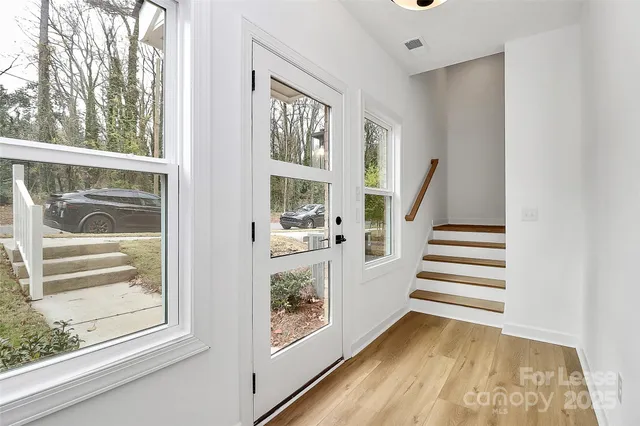 a view of entryway with wooden floor and door