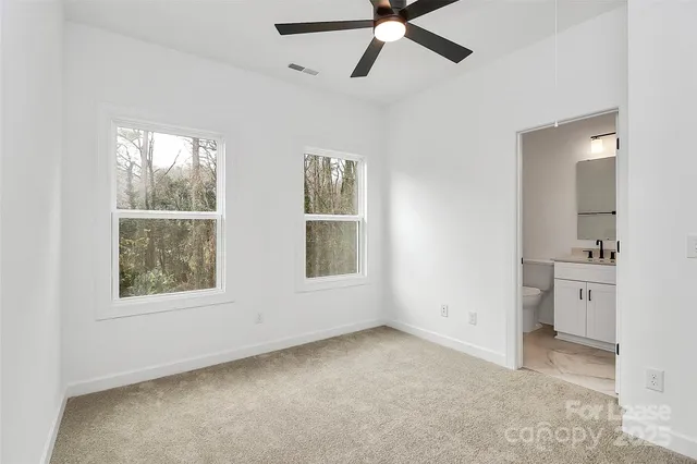 an empty room with windows and cabinet mirror