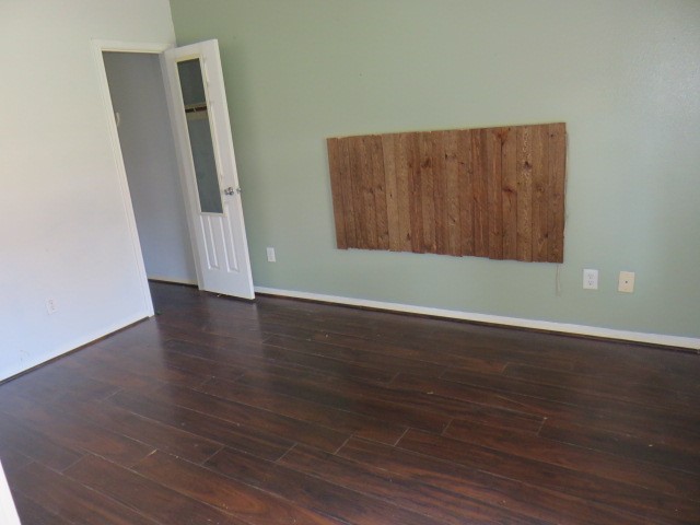 12127 Landsdown Ridge Way Humble, TX 77346 - Photo 11 of 35 an empty room with wooden floor and closet