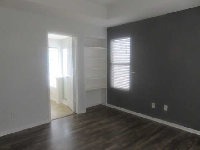 12127 Landsdown Ridge Way Humble, TX 77346 - Photo 18 of 35 an empty room with wooden floor and windows