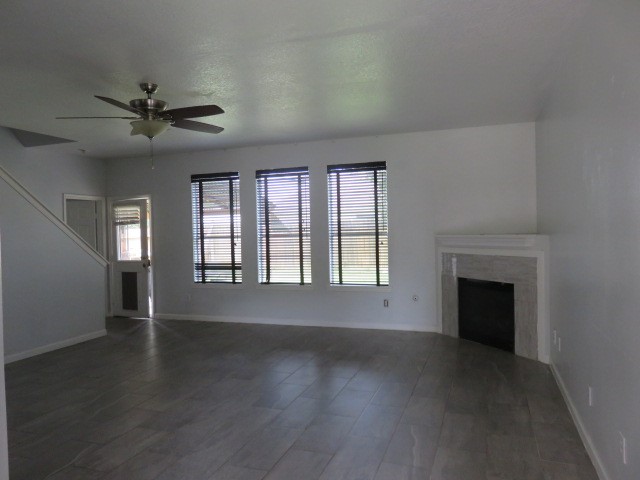 12127 Landsdown Ridge Way Humble, TX 77346 - Photo 2 of 35 an empty room with wooden floor fan and windows