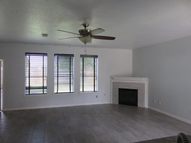 12127 Landsdown Ridge Way Humble, TX 77346 - Photo 3 of 35 a view of an empty room with chandelier fan and fire place