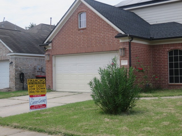12127 Landsdown Ridge Way Humble, TX 77346 - Photo 33 of 35 a front view of a house with garden