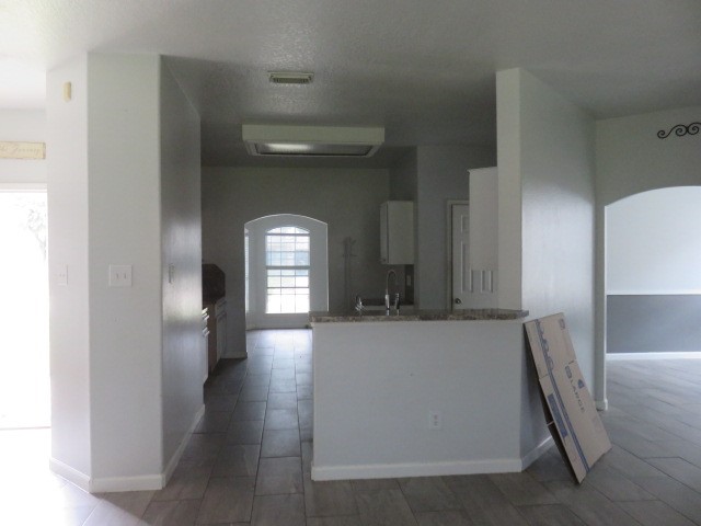 12127 Landsdown Ridge Way Humble, TX 77346 - Photo 4 of 35 a hallway with a large window and wooden floor