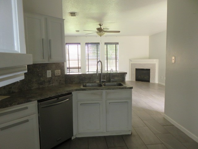 12127 Landsdown Ridge Way Humble, TX 77346 - Photo 9 of 35 a kitchen with granite countertop a sink stainless steel appliances white cabinets and a window