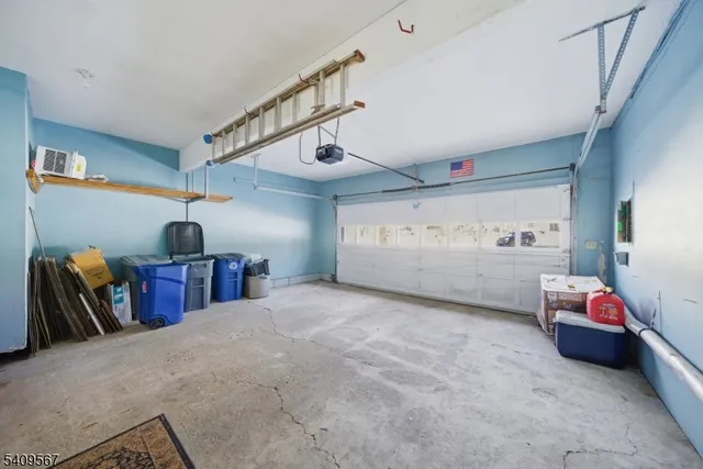 a view of a bedroom with baby crib and furniture