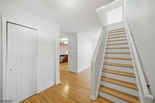 a view of a hallway with wooden floor and entryway