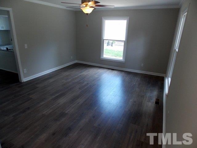 5624 Pelham Road Durham, NC 27713 - Photo 3 of 15 an empty room with wooden floor and windows