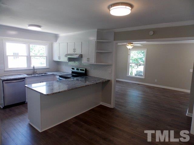 5624 Pelham Road Durham, NC 27713 - Photo 6 of 15 a kitchen with granite countertop a stove and wooden floor