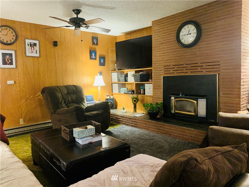 743 Locher Road Touchet, WA 99360 - Photo 4 of 33 a living room with furniture a fireplace and a flat screen tv