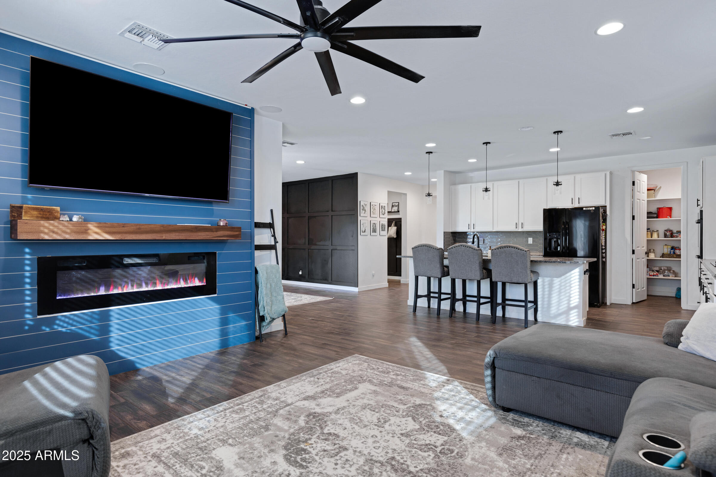 24450 Seed Road Florence, AZ 85132 - Photo 20 of 39 a living room with furniture a flat screen tv and a fireplace