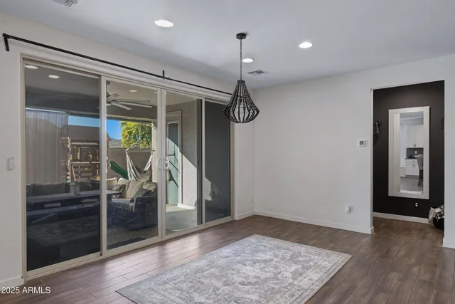 a view of a hallway with wooden floor and windows