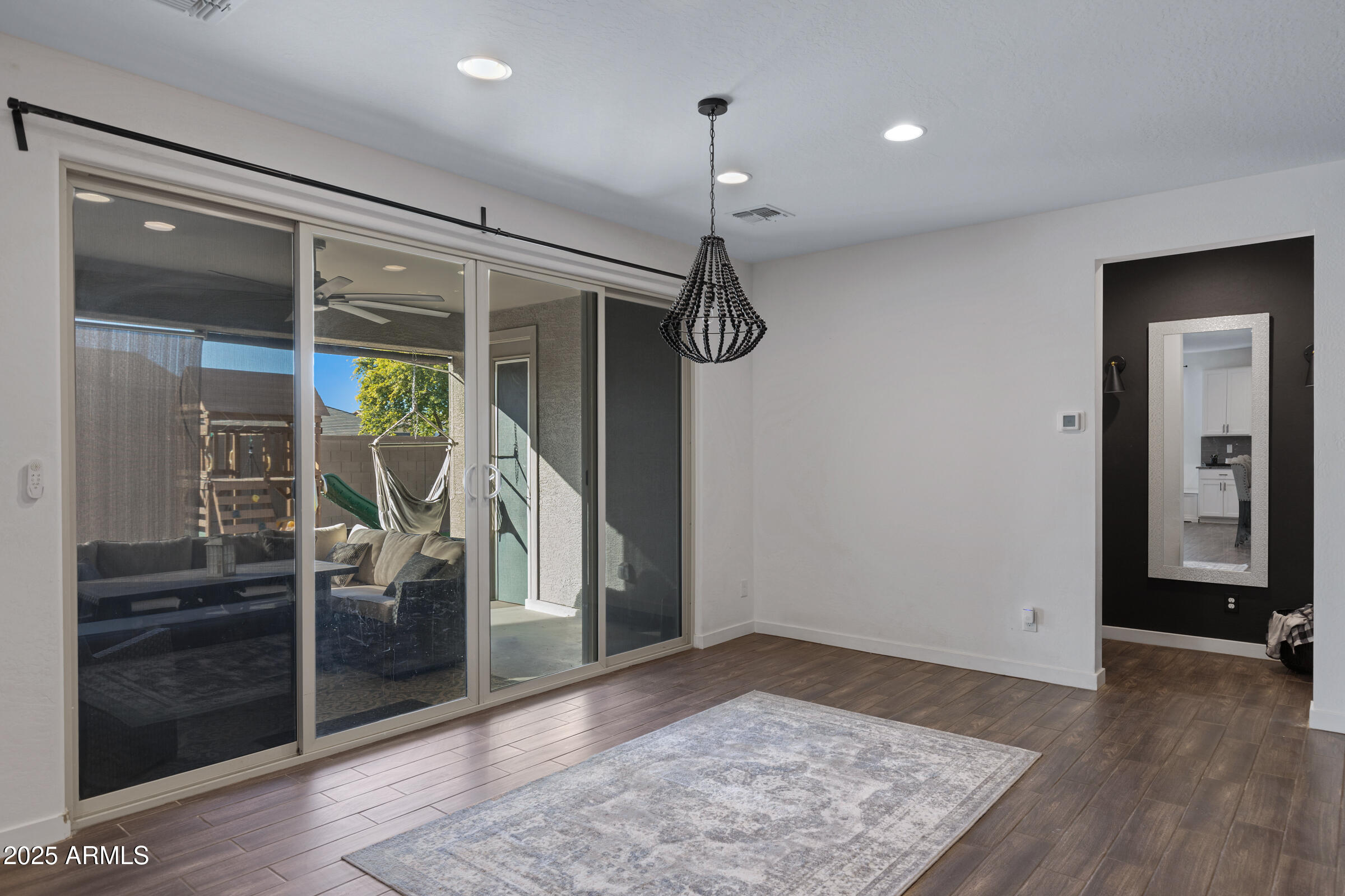 24450 Seed Road Florence, AZ 85132 - Photo 22 of 39 a view of a hallway with wooden floor and windows