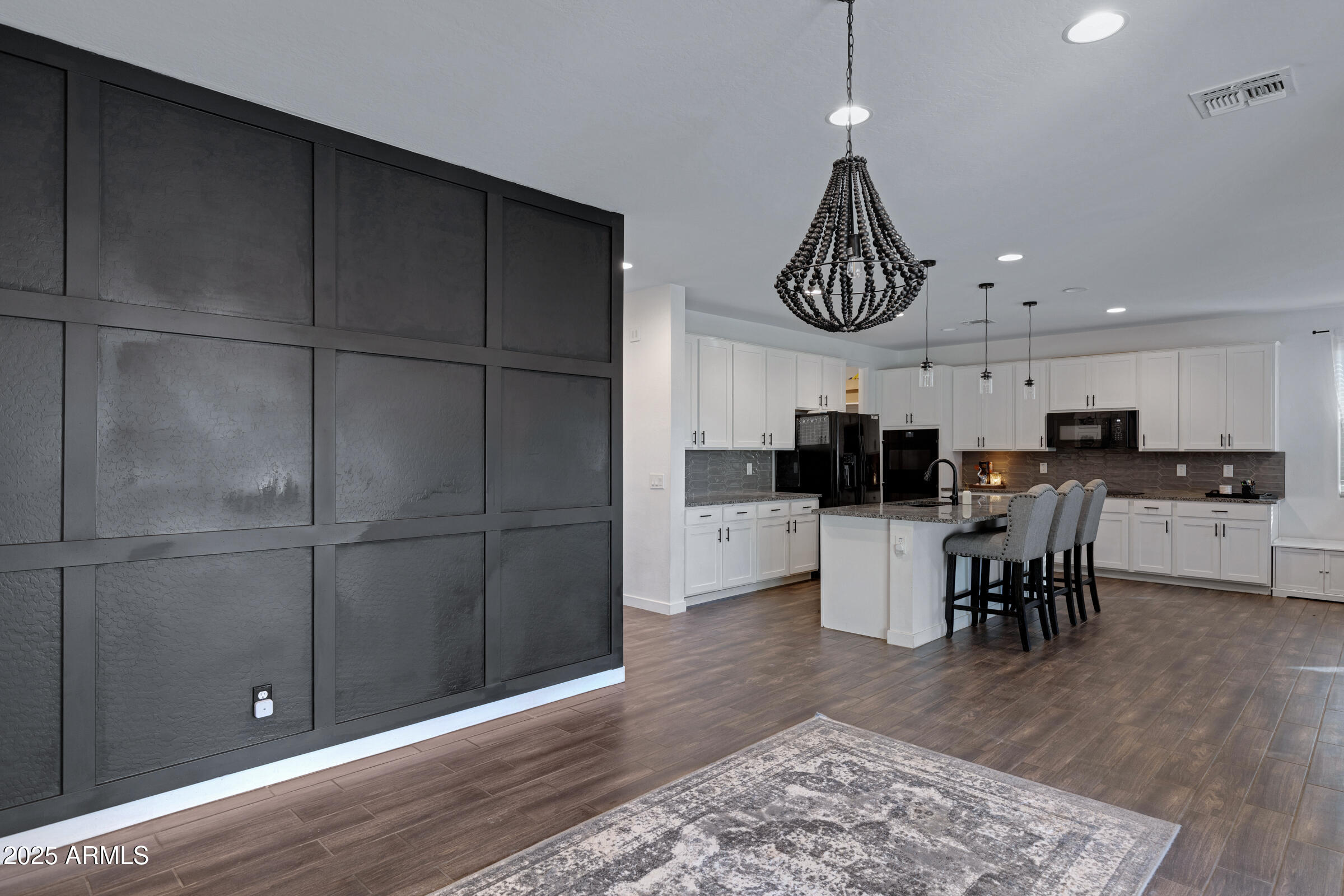 24450 Seed Road Florence, AZ 85132 - Photo 23 of 39 a kitchen with stainless steel appliances kitchen island granite countertop a refrigerator a stove a microwave oven a sink with a dining table and chairs