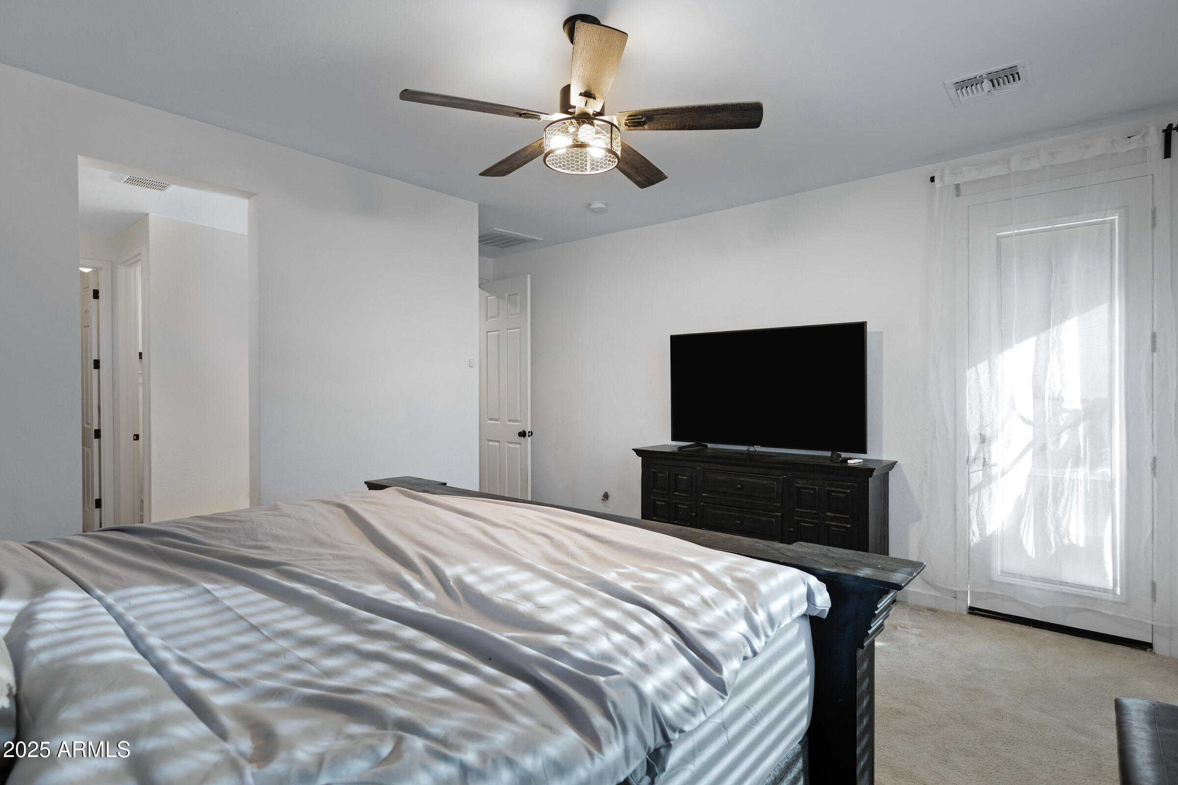 24450 Seed Road Florence, AZ 85132 - Photo 26 of 39 a bedroom with a bed and a flat screen tv