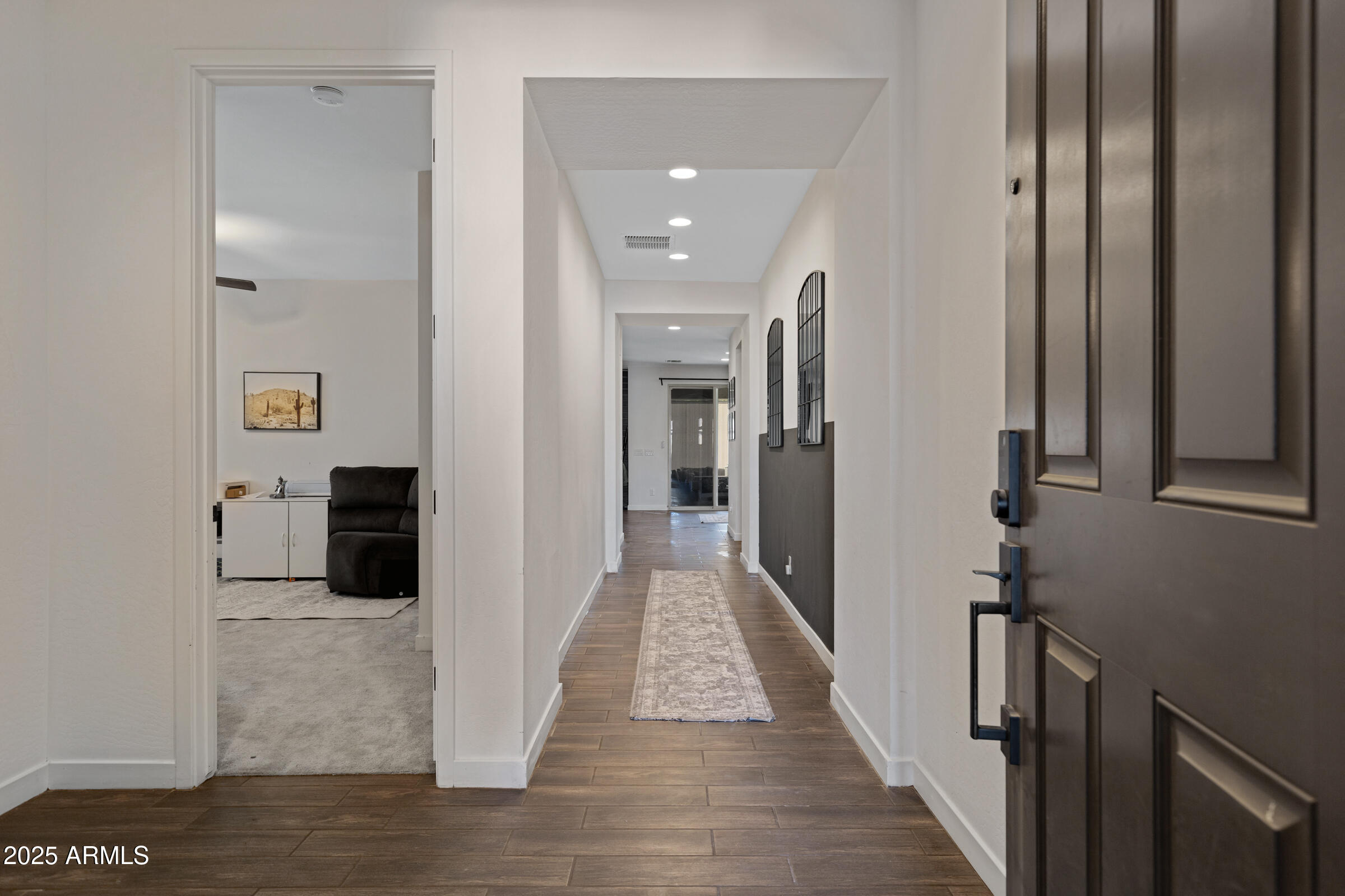 24450 Seed Road Florence, AZ 85132 - Photo 6 of 39 a view of a hallway with wooden floor and staircase