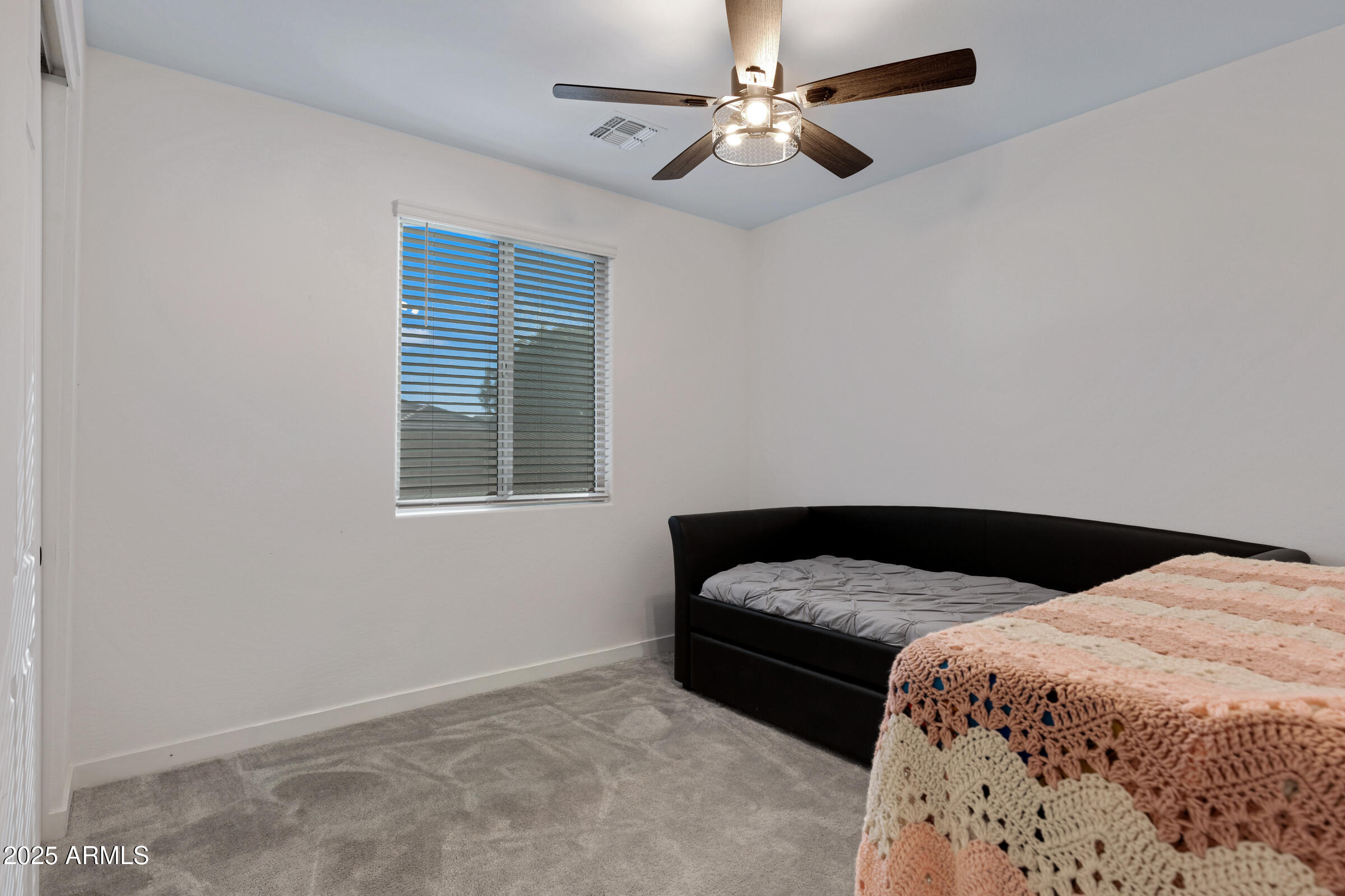 24450 Seed Road Florence, AZ 85132 - Photo 9 of 39 a bedroom with a bed ceiling fan and a window