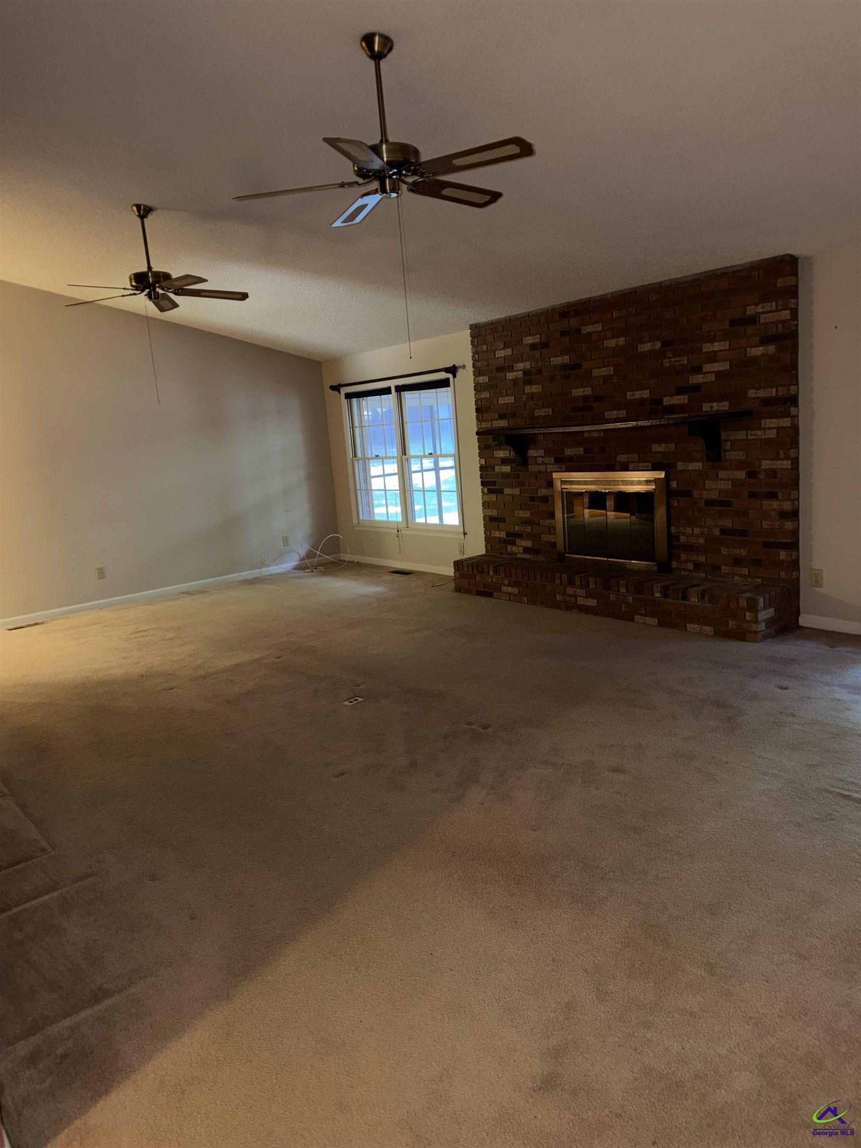 249 Hatcher Road Warner Robins, GA 31088 - Photo 11 of 25 a view of empty room with a fireplace