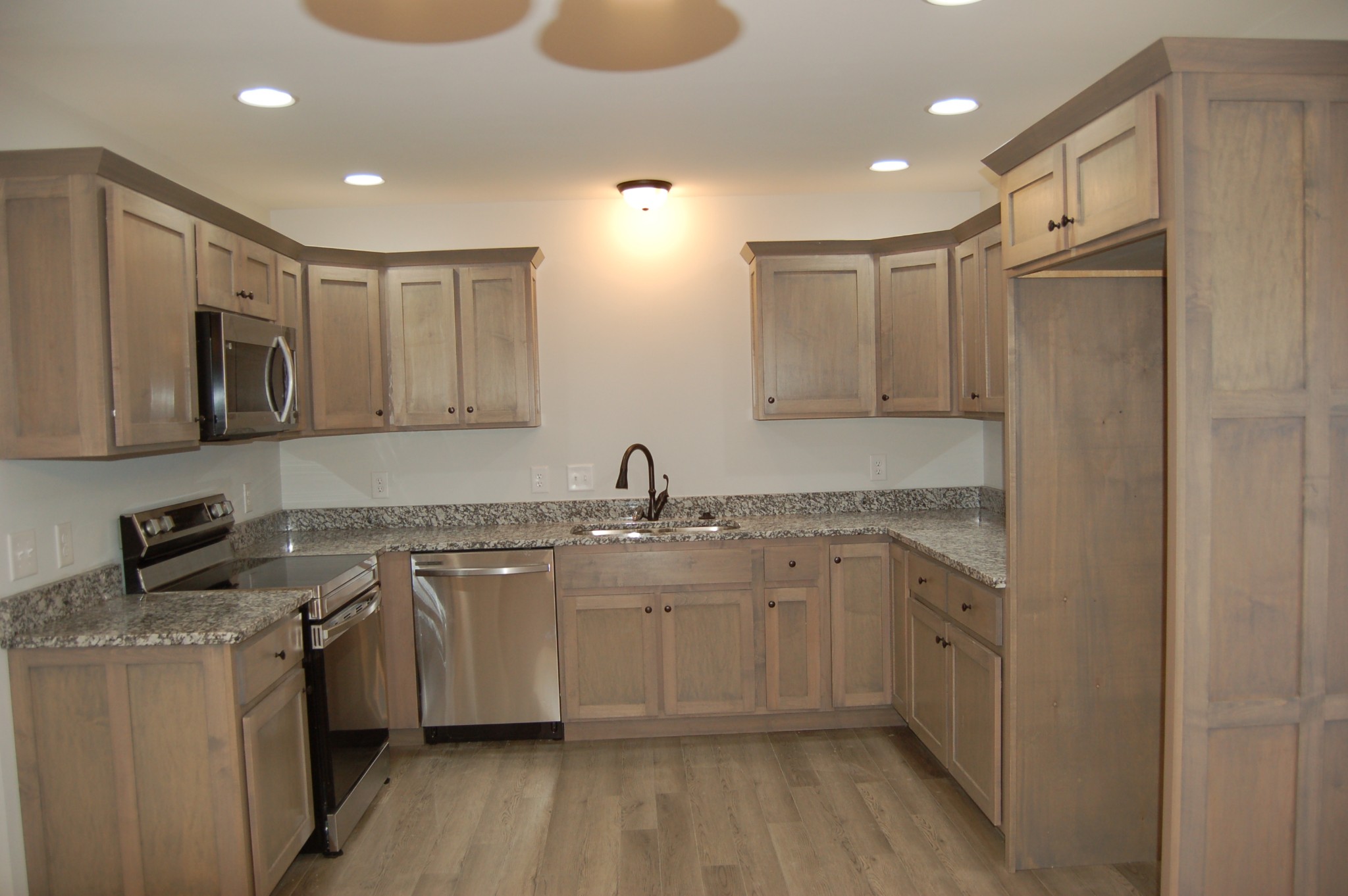 183 Scattersville Road Portland, TN 37148 - Photo 4 of 11 a kitchen with stainless steel appliances granite countertop a sink stove and refrigerator