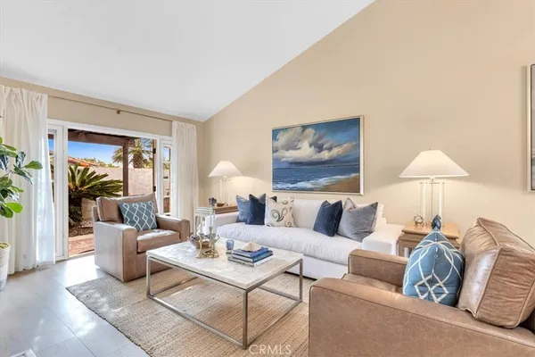 a living room with furniture and a lamp
