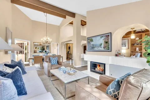 a living room with furniture a fireplace and a table