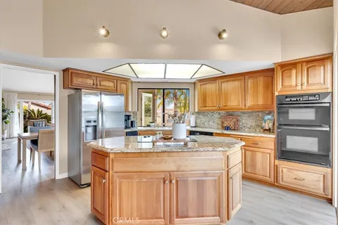 a kitchen with stainless steel appliances granite countertop a stove and refrigerator