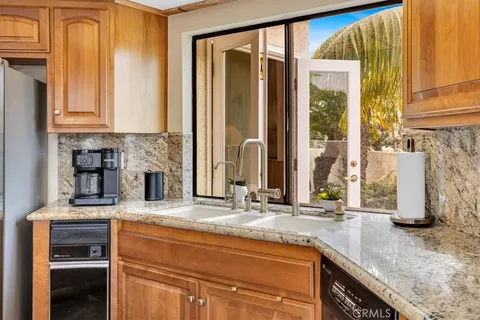 a kitchen with granite countertop a sink and a window
