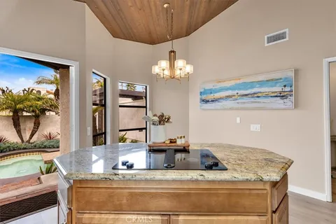 a bathroom with a granite countertop sink and a large mirror