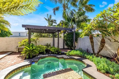 a view of a backyard with plants and a patio