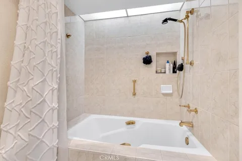 a bathroom with a granite countertop sink a mirror and vanity