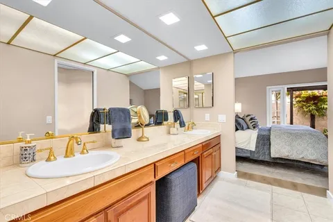 a bathroom with a granite countertop sink a large mirror and a shower