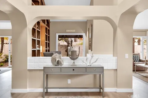 a view of living room with furniture and mirror
