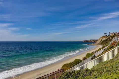 a view of a patio with dining table and chairs